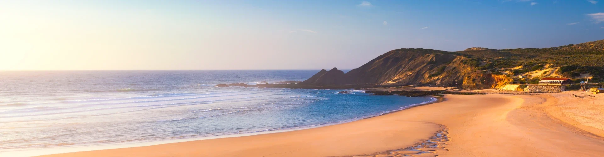 Amoreira Beach in Aljezur, Algarve, Portugal — where the river meets the Atlantic Ocean along a wide stretch of golden sand.