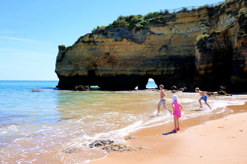 Moving to Portugal with Family 3 children playing at the beach in portugal