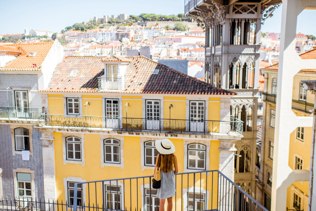 Moving to Portugal from the USA 4 Lisbon city view featuring the Santa Justa Elevator, nearby buildings, and the hilltop castle