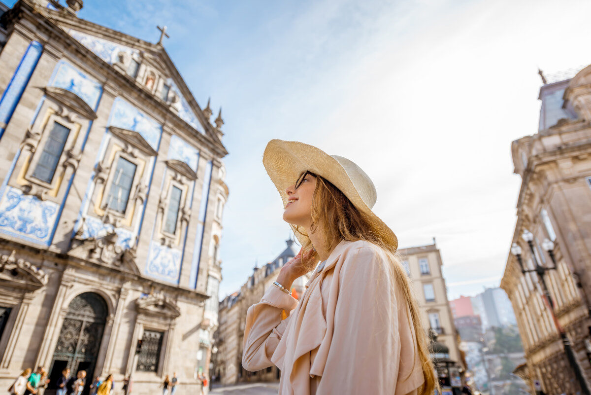 Woman walking near the Church of the Congregados in the historic center of Porto, Portugal