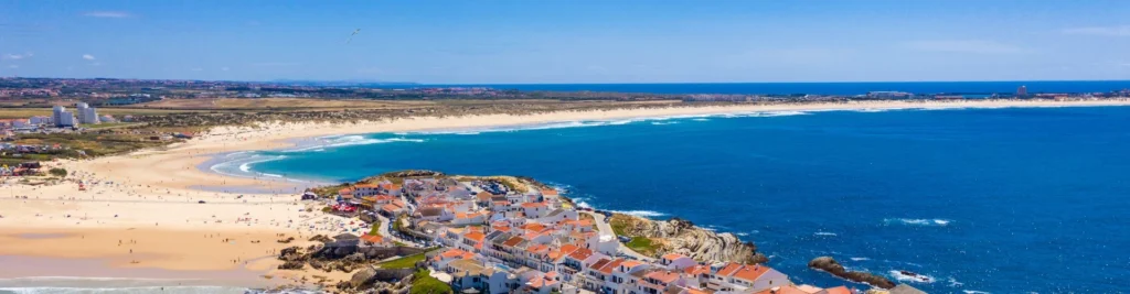 Aerial view of Baleal, Portugal — coastal village with sandy beach and Atlantic waves.