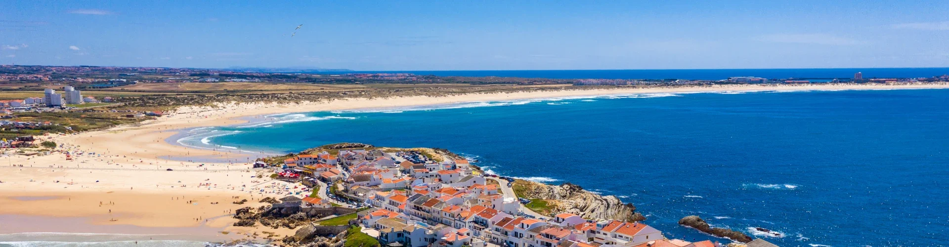 Aerial view of Baleal, Portugal — coastal village with sandy beach and Atlantic waves.