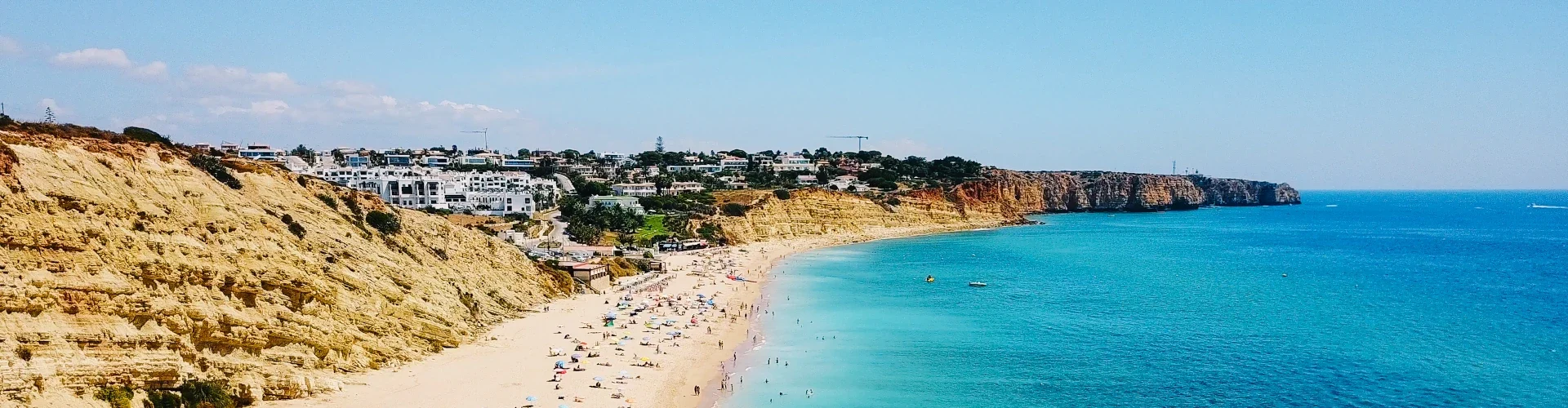 Coastal view of an Algarve beach in southern Portugal, with cliffs and clear Atlantic water.