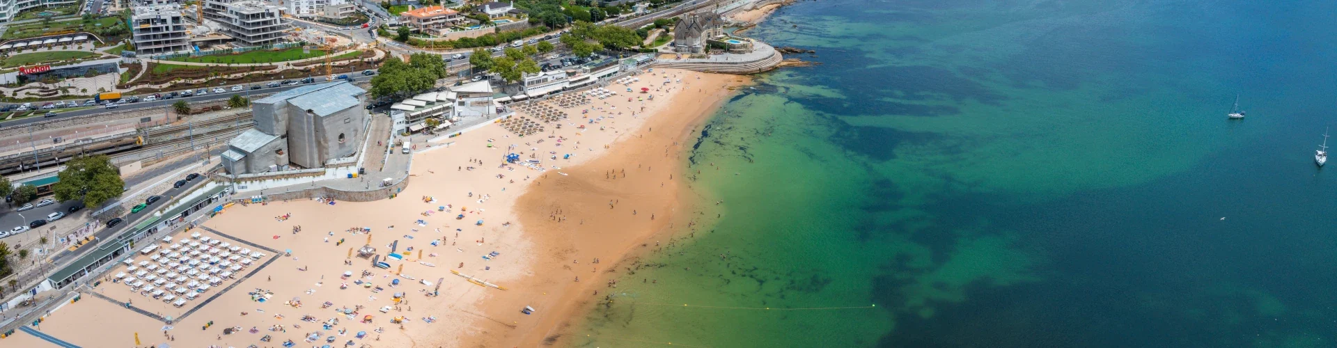 Aerial view of Cascais, Portugal, showing the coastline and beach area.